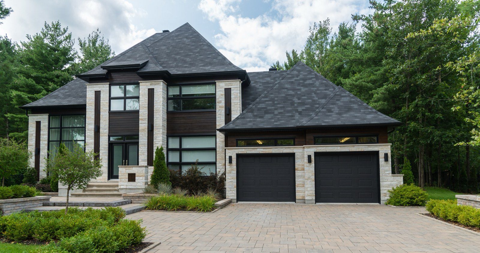 Contemporary two-storey home with stone and dark timber cladding