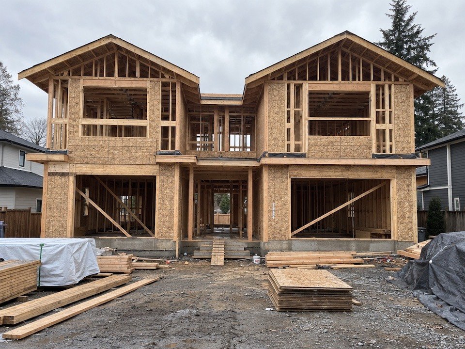 A two-storey duplex at the framing stage